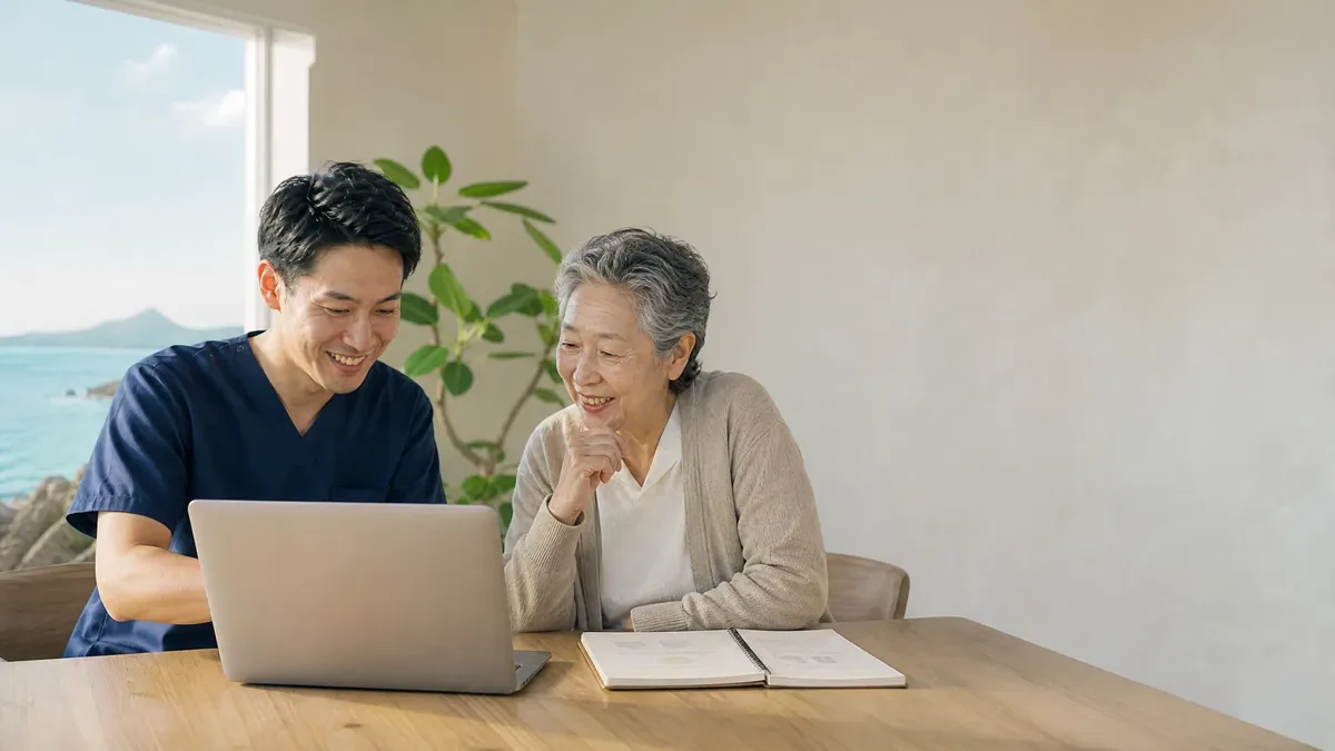 パソコンの画面を一緒に見るスタッフと利用者